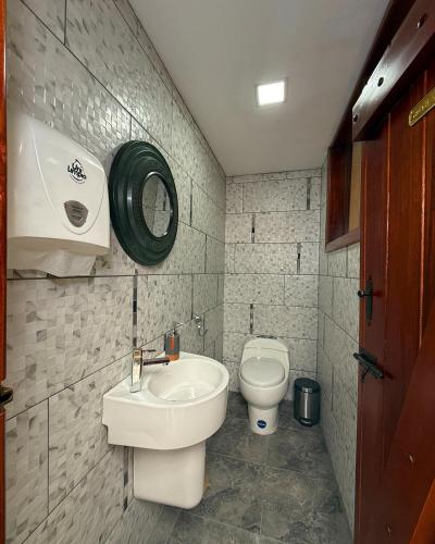 a small bathroom with a sink and a toilet at Casa Colonial Centro Histórico in Quito