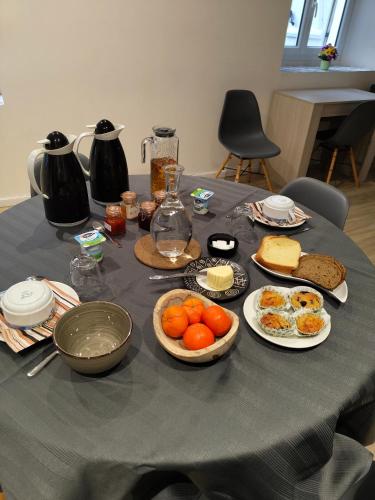 a table with plates of food on top of it at Gîte des Pleiades in Villemoirieu
