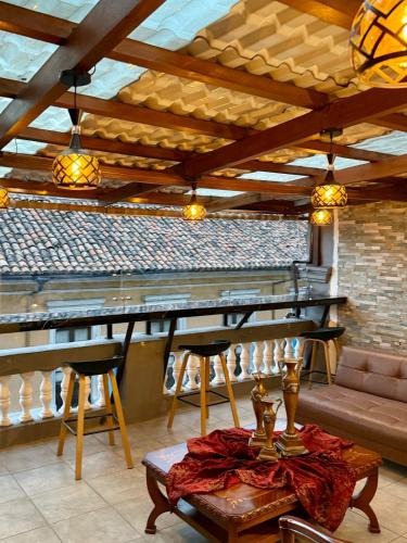 a room with a bar with a table and chairs at Casa Colonial Centro Histórico in Quito