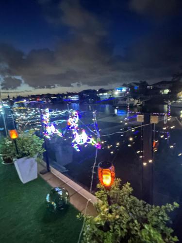 a view of a city at night with christmas lights at Canal living 3 bed or 1 bed with Pool in Redcliffe