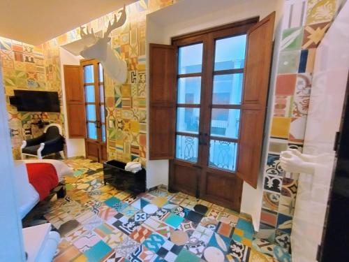 a room with a floor covered in colorful tiles at Del Carmen Concept Hotel Boutique by Chai in Guadalajara