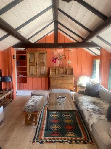 a living room with a couch and a table at Geilo, two cabins, silence, nature, skiing and summer sports in Geilo