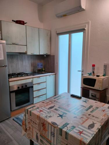 a kitchen with a table with a box on it at Stella Marys Sud in Olbia