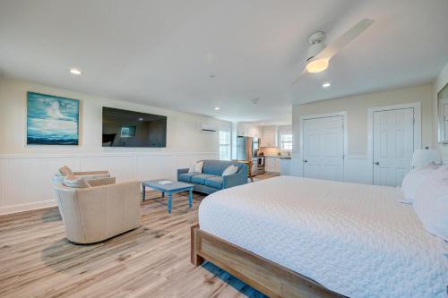 a bedroom with a bed and a couch and a chair at 3008 King Suite, 3rd Floor Serenity in Surf City