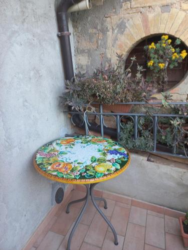 a colorful table sitting in front of a brick oven at Fattoria di Rigone in Coltavolino