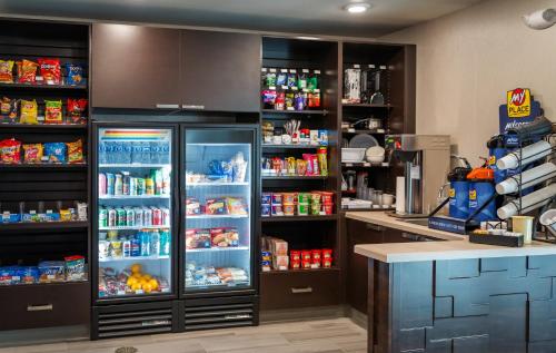 a kitchen with an open refrigerator filled with food at My Place Hotel-Hastings, NE in Hastings