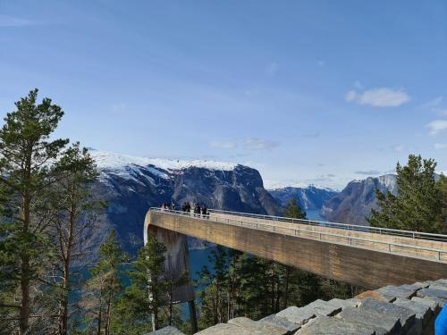 people standing on a bridge in the mountains at Over the Fjord in Leikanger