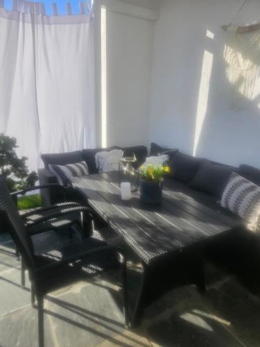 a living room with a black table and a couch at Over the Fjord in Leikanger