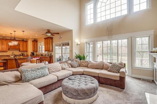 a living room with a large couch and a kitchen at 3 Mi to Shore Spacious Gem with Yard in Cape May in Cape May