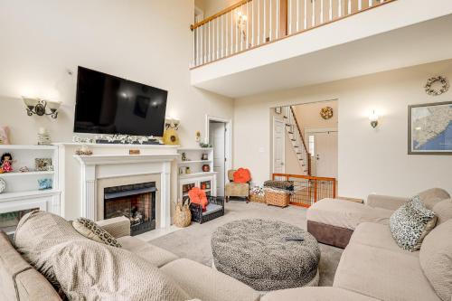 a living room with a fireplace and a tv at 3 Mi to Shore Spacious Gem with Yard in Cape May in Cape May