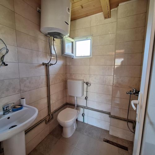 a bathroom with a toilet and a sink at Cottage Kolomza in Ulcinj