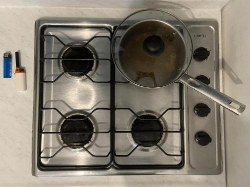 a pot sitting on top of a stove at Maracuyá Hostal Zipolite in Zipolite