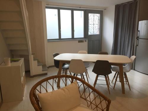 a dining room with a table and chairs at Maison Cosy centre de Pouzauges in Pouzauges