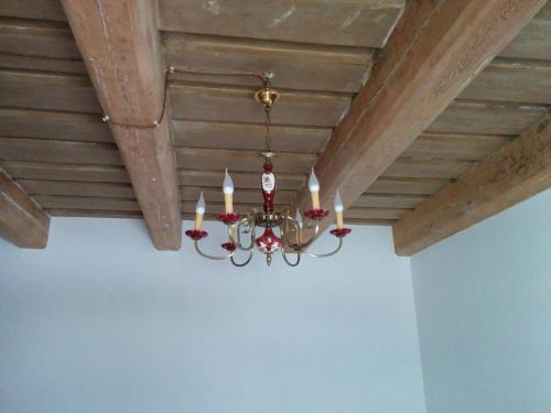 a chandelier hanging from a wooden ceiling at Viesu Nams Vilhelmīne in Līgatne