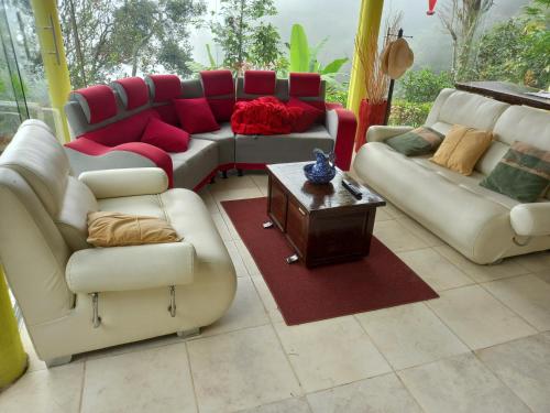 a living room with couches and a coffee table at EL Refugio in La Vega
