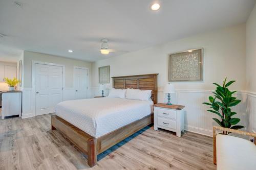 a bedroom with a bed and a plant in it at Adjacent 3rd Floor Trio, 3001 King, 3002 Queen, & 3003 Queen in Surf City