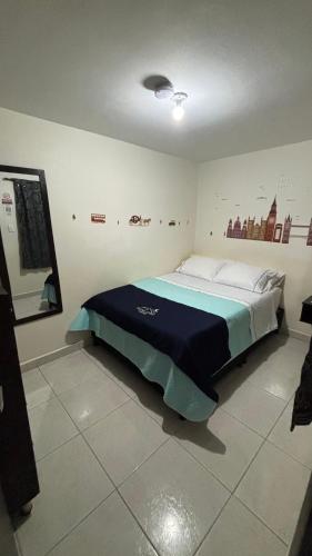 a bedroom with a large bed in a room at Hotel Casa Luna in Bogotá