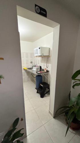 an office with a desk and a microwave in a room at Hotel Casa Luna in Bogotá