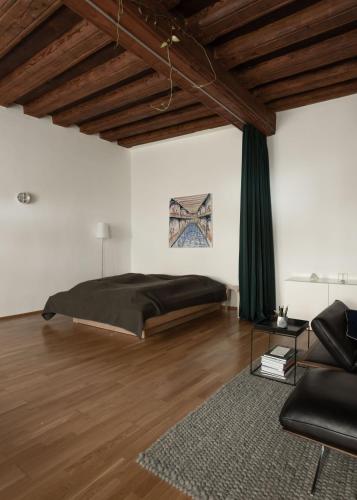 a bedroom with a bed and a couch at Studio 12 in Linz