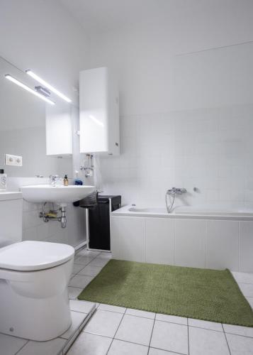 a bathroom with a toilet and a sink and a tub at Studio 12 in Linz