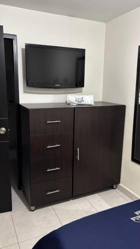 a flat screen tv sitting on top of a dresser at Hotel Casa Luna in Bogotá