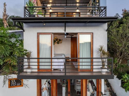 a house with a balcony with a deck at Yaloco House Monteverde in Monteverde Costa Rica