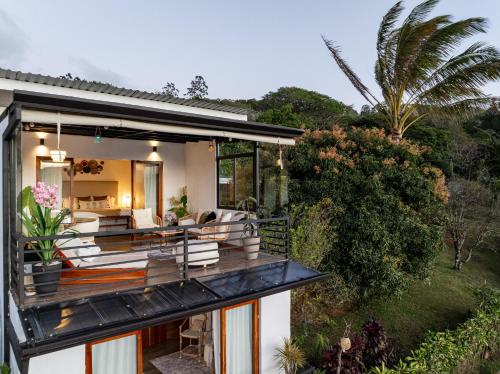 a house with a wrap around deck with a living room at Yaloco House Monteverde in Monteverde Costa Rica