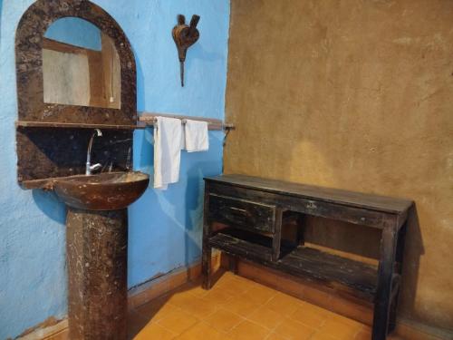 a bathroom with a toilet and a sink in a room at Auberge Itrane in Merzane