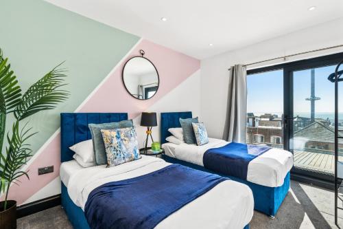 two beds in a room with a large window at Western Seaview Terrace - Central - Contractors in Brighton & Hove
