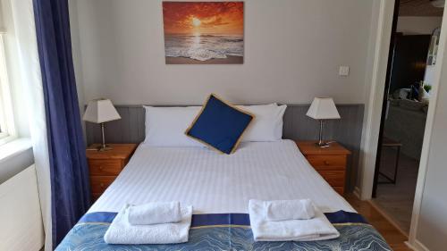 a bedroom with a bed with two pillows on it at Dolphin Watch in Fanore
