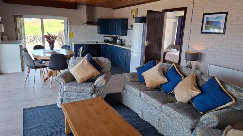 a living room with two couches and a table at Dolphin Watch in Fanore