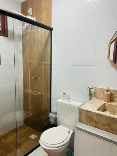 a bathroom with a toilet and a shower and a sink at Margarida 01 in Monte das Gameleiras