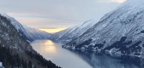 a view of a river between two mountains at Over the Fjord in Leikanger