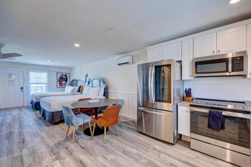 a kitchen with a bed and a table in a room at 302 Queen Suite, 3rd Floor Low Tide in Surf City