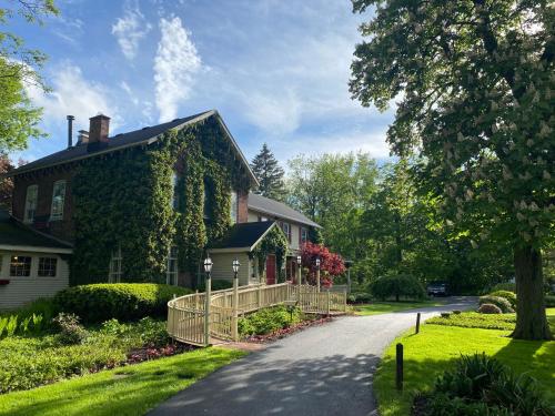 a house with ivy on the side of a road at Asa Ransom House in Clarence