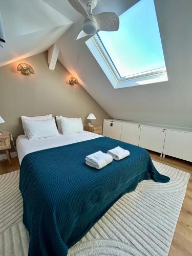 une chambre avec un lit avec deux serviettes dessus dans l'établissement La belle Deauvillaise, à Deauville