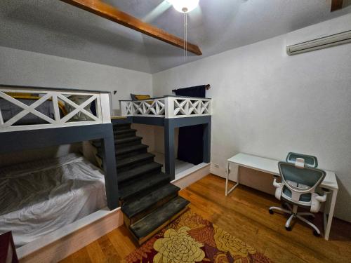 a room with a bunk bed and a desk and a chair at Oceanfront Dock of the Bay Retreat in Scotts Hill