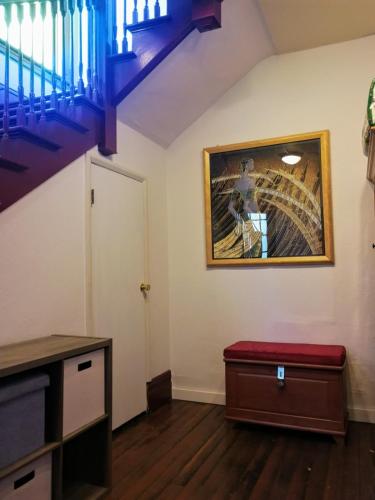 a living room with a staircase and a red bench at #2 Walking distance to Seattle Capitol Hill Downtown in Seattle