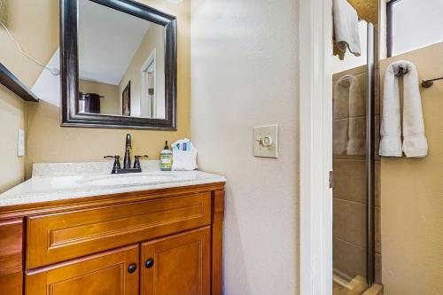 a bathroom with a sink and a mirror and a shower at Fairway View Permit# STR2021-0301 in Palm Desert