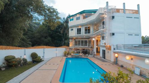 an exterior view of a house with a swimming pool at Elicon Suites in Tagbilaran City