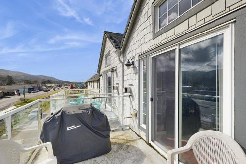 a balcony with a view of a house at A Place away from the Pace in Rockaway Beach