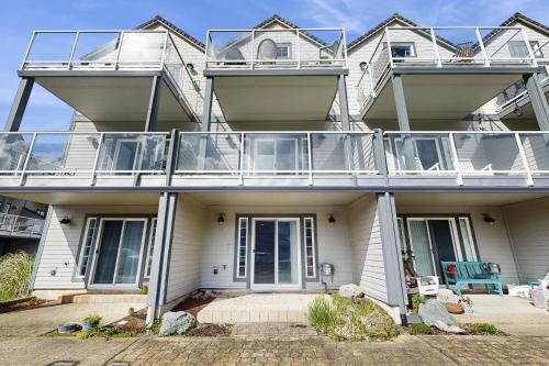 an apartment building with a large balcony on it at A Place away from the Pace in Rockaway Beach