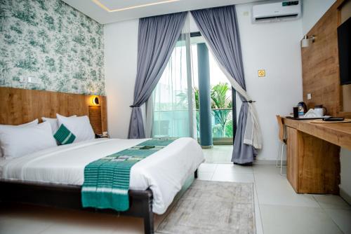 Postel nebo postele na pokoji v ubytování Hotel Yatchenin Abidjan