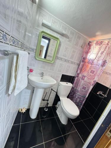 a bathroom with a toilet and a sink at Dar Yema in Asilah
