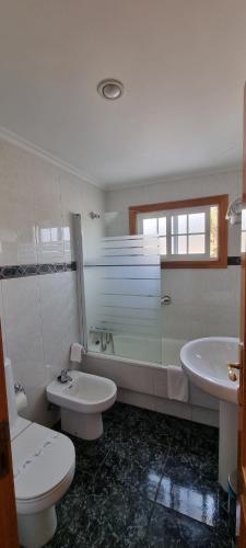 a bathroom with a toilet and a sink at Hotel Miramar Playa America Nigran in Nigrán