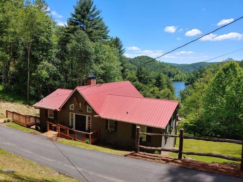 a house with a red roof on the side of a road at Stunning Modern Rustic Lake Retreat PRVT BOAT SLIP in Cullowhee