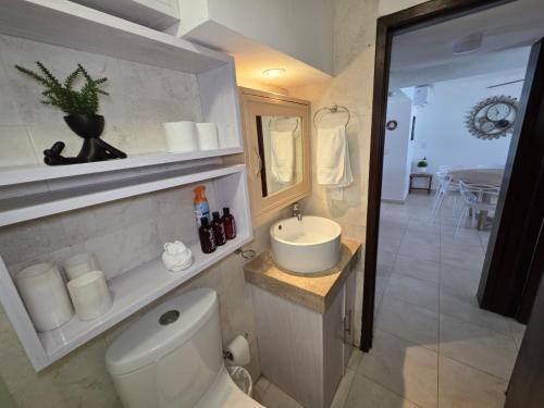 a bathroom with a toilet and a sink at Perfect vacation getaway,Ocean View,Wifi, Beach in Cancún