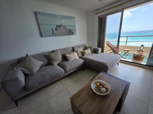 a living room with a couch and a table at Perfect vacation getaway,Ocean View,Wifi, Beach in Cancún