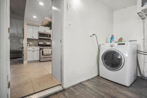 a kitchen with a washing machine in a room at The Perfect Vacation Spot Near Six Flags Magic Mountain in Santa Clarita