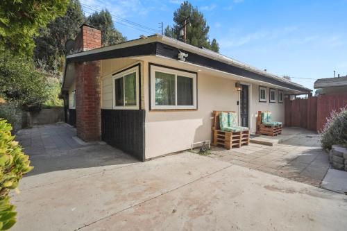 a small house with a garage in a driveway at The Perfect Vacation Spot Near Six Flags Magic Mountain in Santa Clarita